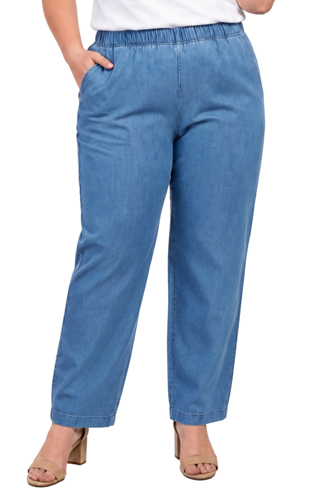 Blue jeans worn by a person on a white background
