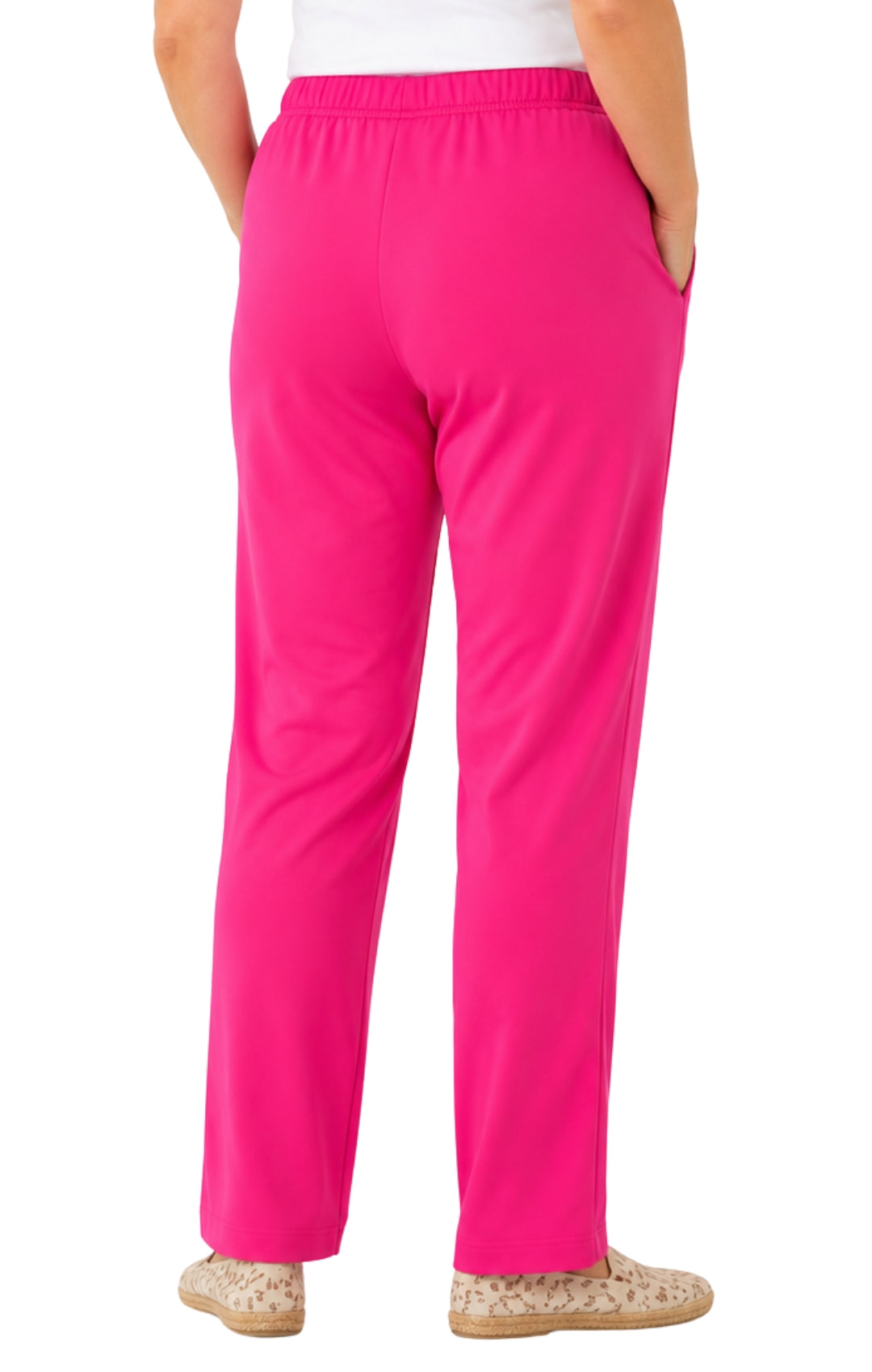 Bright pink pants worn by a person on a white background