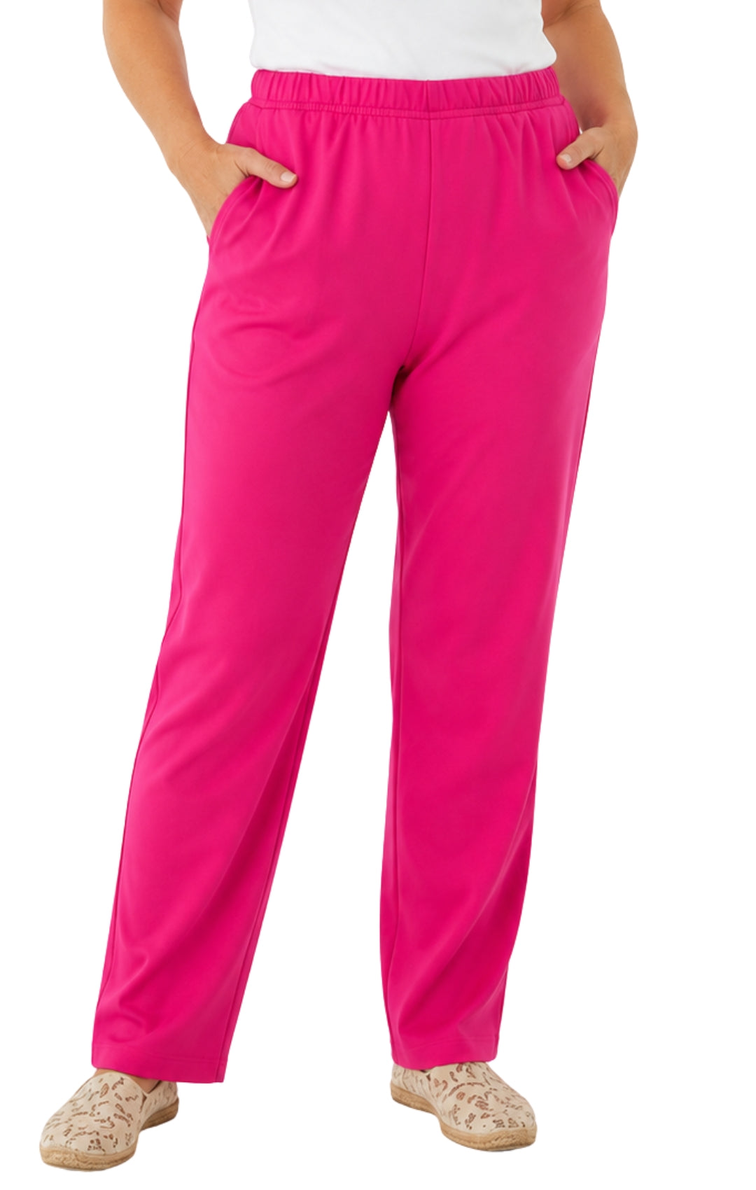 Person wearing bright pink pants on a white background