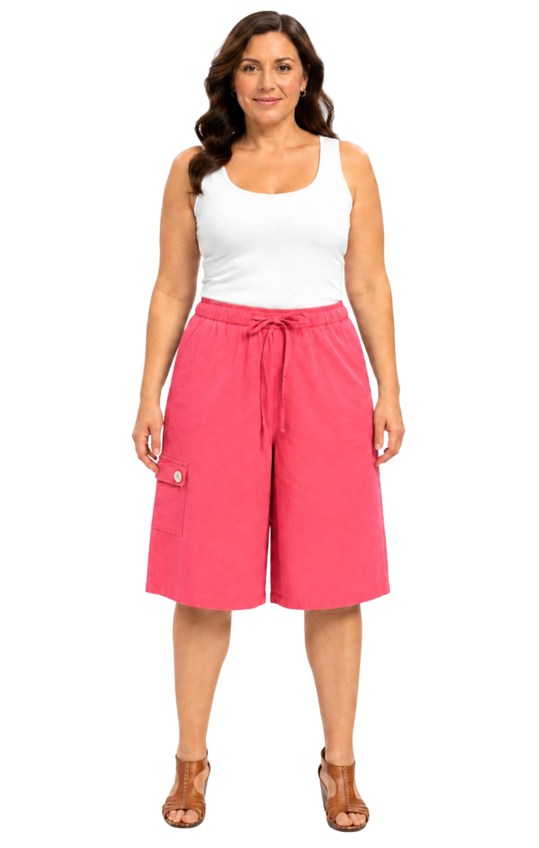 Woman wearing pink shorts and a white tank top on a white background