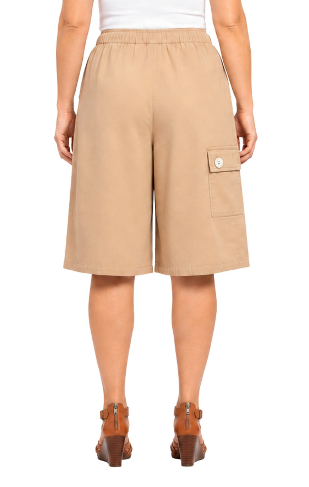 Beige shorts worn by a person on a white background