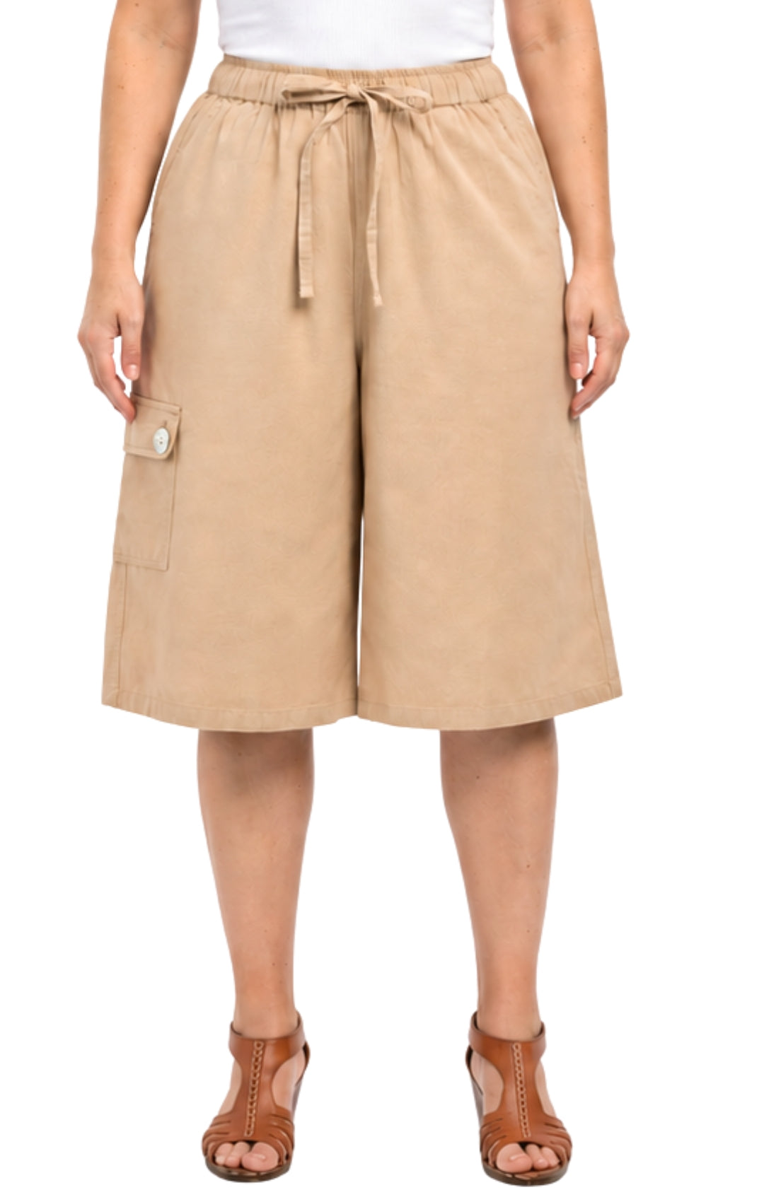 Beige shorts worn by a person on a white background